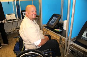 Man in wheelchair in voting booth
